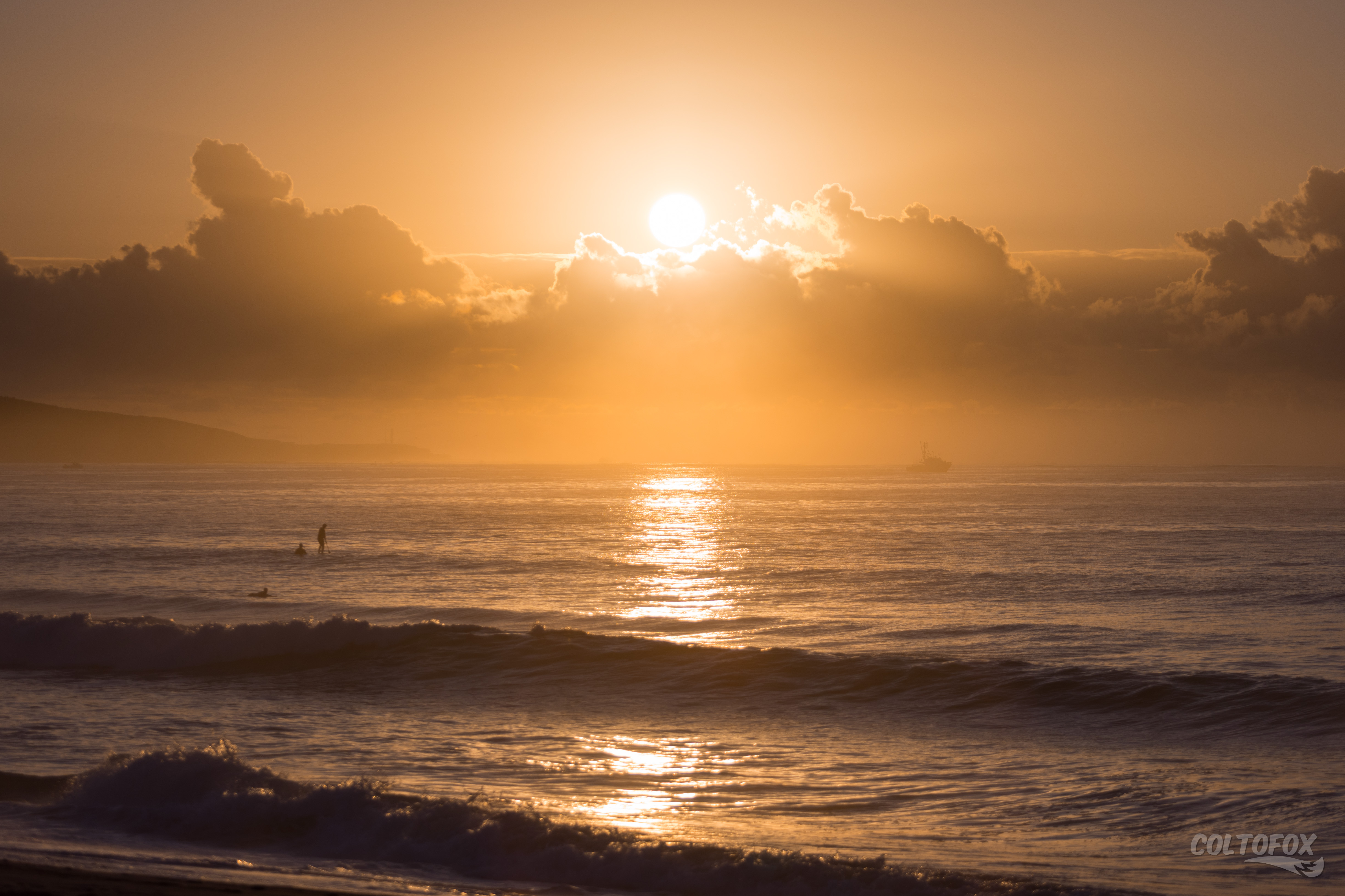 The sun rising over some clouds over the Pacific Ocean.