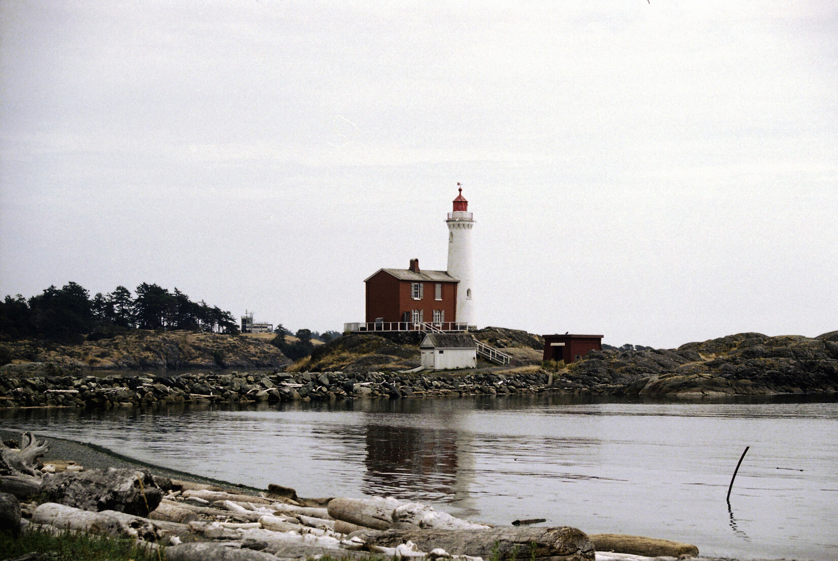 A photo of a light house at a coast.